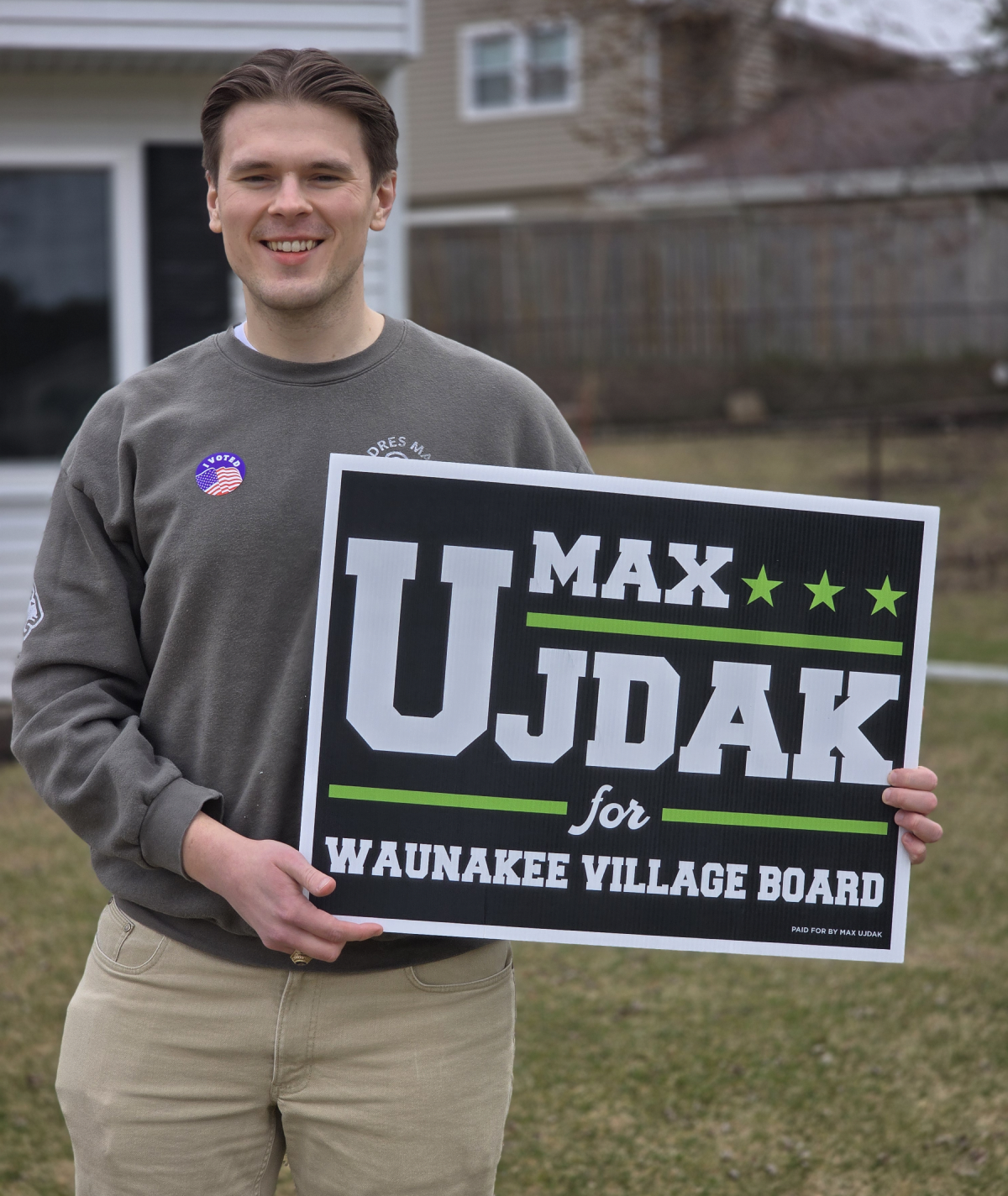 Man holding election campaign sign outdoors