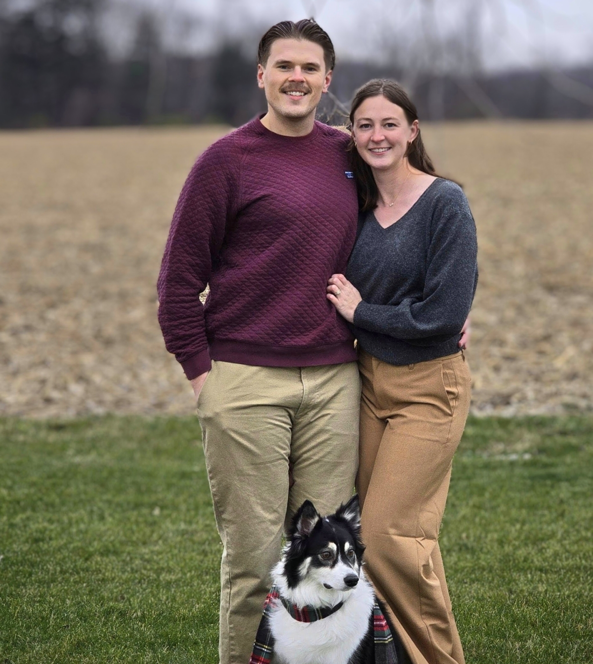 Couple with dog in a field