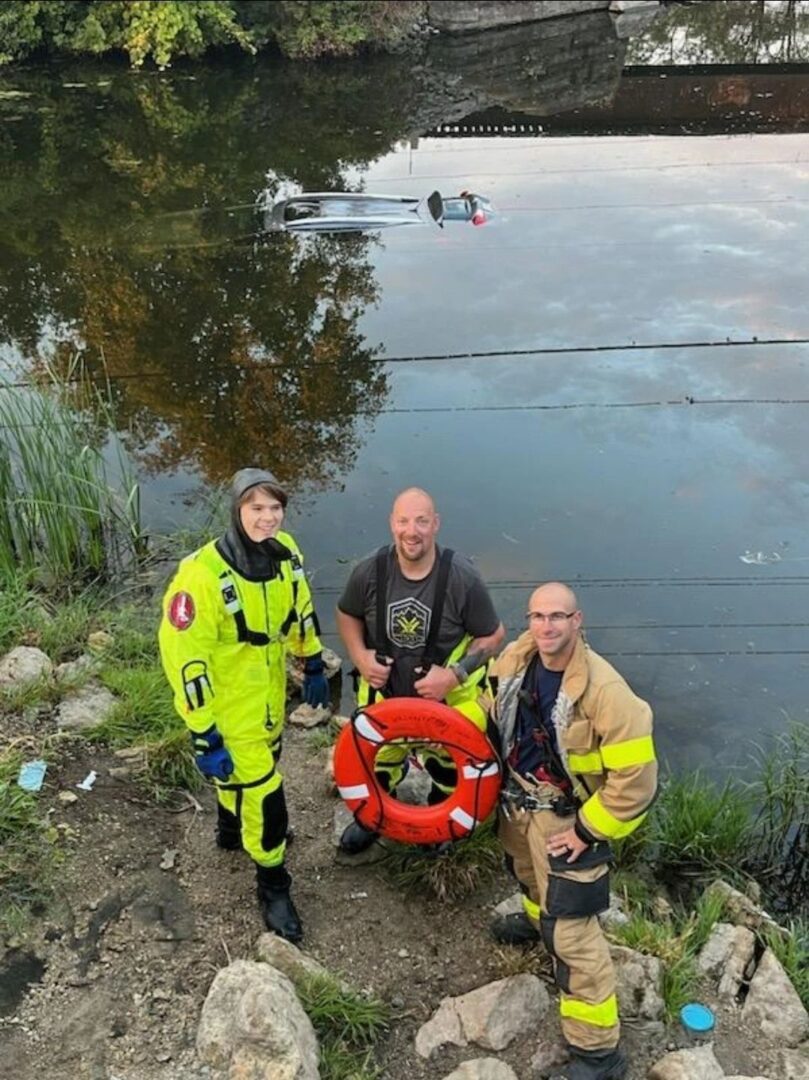 Max Ujdak stands at the edge of the Yahara River for a water rescue